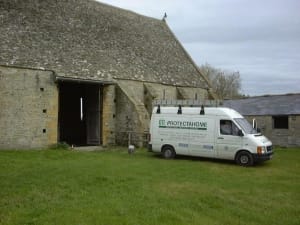 A Protectahome van outside a stone building.