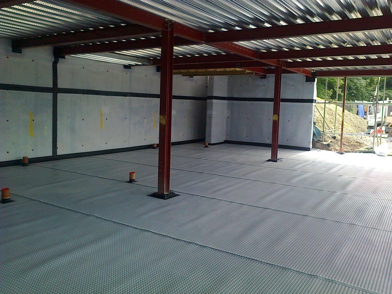 DURING: Cavity Drain Membrane Installed to Earth Retaining Elevations and Floor